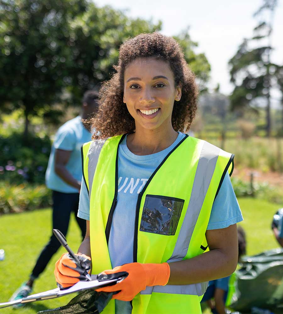 Volunteer with a clipboard coordinating a community event