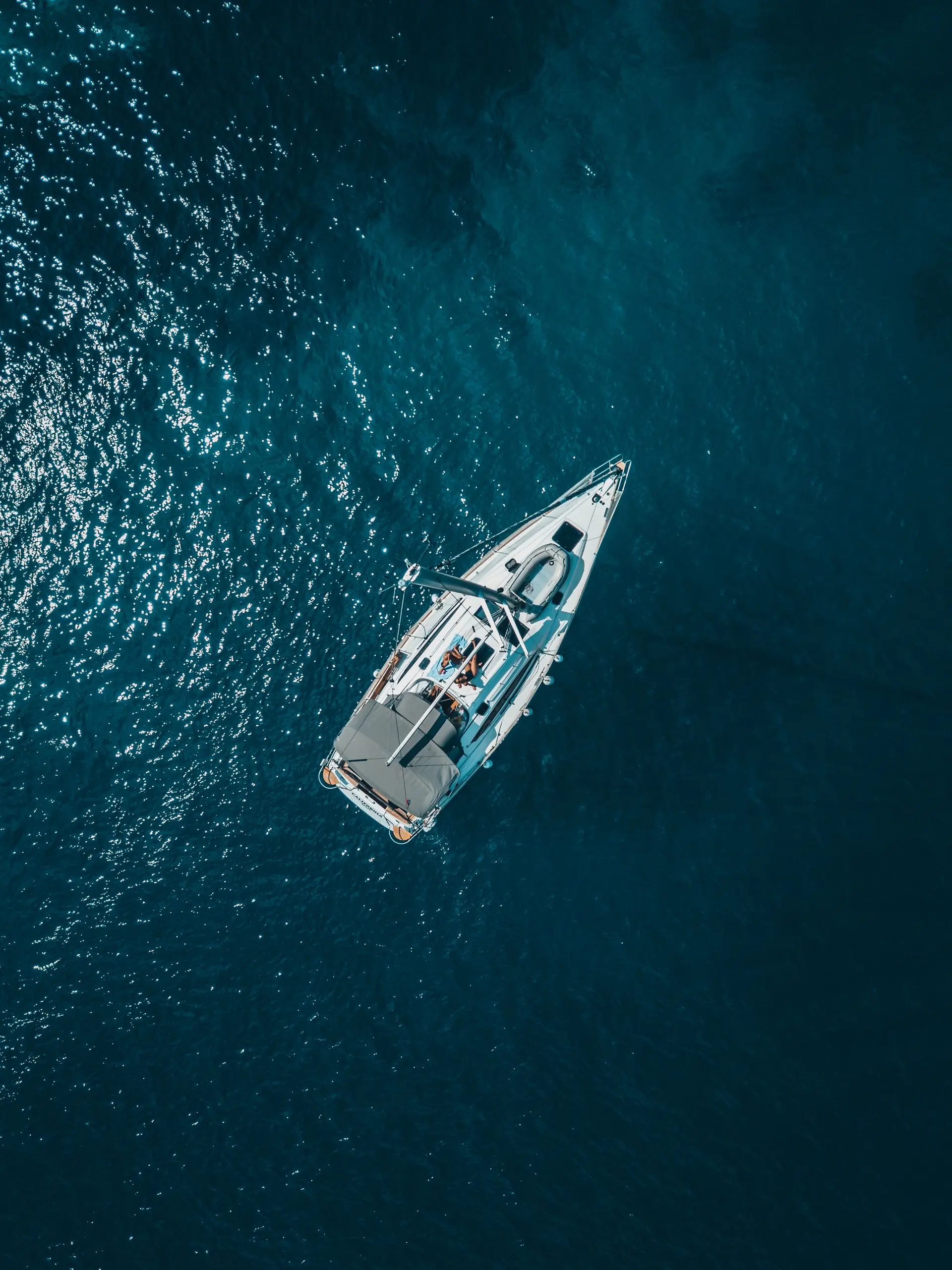 Aerial view of a yacht on deep blue water